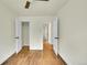 Neutral bedroom showcasing natural wood floors, white trim, doors and closets and neutral walls at 495 Quebec St, Denver, CO 80220