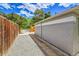 Side view of the house showing the rock landscaping, fence and exterior brick and siding at 495 Quebec St, Denver, CO 80220