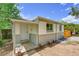 Charming single-story home with brick accents, a covered front porch, and a well-maintained yard at 495 Quebec St, Denver, CO 80220