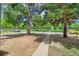 Spacious front yard featuring mature trees, a stone walking path and shade at 495 Quebec St, Denver, CO 80220