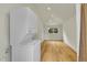 Laundry room featuring a stacked washer and dryer with wood floors, recessed lights and a window at 495 Quebec St, Denver, CO 80220