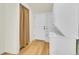 View of the laundry area with a stacked washer and dryer unit and a door and curtain at 495 Quebec St, Denver, CO 80220