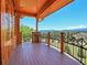 Wood balcony with mountain view, metal railing, wood support posts, and blue sky at 29590 Buchanan Dr, Evergreen, CO 80439