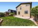 Well-maintained backyard with green grass, patio, privacy fence, and side yard space at 11089 Woodhurst Cir, Highlands Ranch, CO 80130