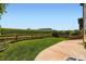An expansive backyard featuring a well-maintained lawn, fenced perimeter, and comfortable patio space at 11089 Woodhurst Cir, Highlands Ranch, CO 80130