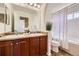 Double sink bathroom with neutral color palette and updated fixtures at 11089 Woodhurst Cir, Highlands Ranch, CO 80130