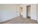 Bright bedroom with neutral colored walls, carpet floors, closet with doors, and entry door at 11089 Woodhurst Cir, Highlands Ranch, CO 80130