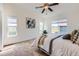 Bright bedroom with neutral color palette, plush carpet, and ample natural light at 11089 Woodhurst Cir, Highlands Ranch, CO 80130