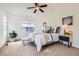 Bright, spacious bedroom featuring a ceiling fan, plush carpeting, and decorative furniture at 11089 Woodhurst Cir, Highlands Ranch, CO 80130