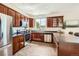 Well-equipped kitchen features stainless steel appliances, wood cabinets, and granite countertops at 11089 Woodhurst Cir, Highlands Ranch, CO 80130
