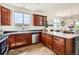 Bright kitchen features wood cabinets, a spacious countertop and stainless steel appliances at 11089 Woodhurst Cir, Highlands Ranch, CO 80130