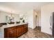Modern kitchen design features wood cabinets, central island, and flows into other rooms at 11089 Woodhurst Cir, Highlands Ranch, CO 80130