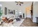 Bright living room featuring high ceilings, a stone fireplace, and stylish decor at 11089 Woodhurst Cir, Highlands Ranch, CO 80130