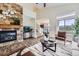 Inviting living room boasts a stone fireplace, wood floors and decor at 11089 Woodhurst Cir, Highlands Ranch, CO 80130