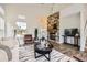 Bright living room boasts a stone fireplace, wood floors and decor at 11089 Woodhurst Cir, Highlands Ranch, CO 80130