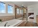 Elegant bathroom featuring a soaking tub, glass shower, and modern fixtures at 20826 Robins Dr, Denver, CO 80249