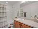 Bright bathroom featuring a tub with shower, vanity with a sink, and a large mirror at 20826 Robins Dr, Denver, CO 80249