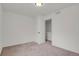 A clean bedroom with neutral carpet and white walls leads to a closet for storage at 20826 Robins Dr, Denver, CO 80249