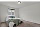 Inviting bedroom featuring a large window, plush carpet, and a comfortable bed with stylish decor at 20826 Robins Dr, Denver, CO 80249