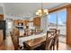 Dining area with wood table and chairs, chandelier, and sliding glass doors at 20826 Robins Dr, Denver, CO 80249