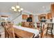 Inviting dining room with a large wooden table and adjacent kitchen area at 20826 Robins Dr, Denver, CO 80249