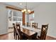 An elegant dining area with a wooden table, stylish chairs, and a chandelier, perfect for Gathering gatherings at 20826 Robins Dr, Denver, CO 80249
