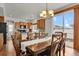 Open dining room with a chandelier, kitchen access, and sliding door to backyard at 20826 Robins Dr, Denver, CO 80249