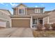 Charming two-story home featuring a covered porch, attached garage, and well-maintained landscaping at 20826 Robins Dr, Denver, CO 80249