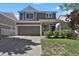 Inviting two-story home with a front-facing two-car garage, complemented by a lush green lawn at 20826 Robins Dr, Denver, CO 80249