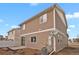 Exterior view of a tan two-story home showcasing the side and back of the house at 20826 Robins Dr, Denver, CO 80249