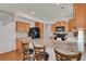 Bright kitchen features a large center island with barstool seating and wood cabinets at 20826 Robins Dr, Denver, CO 80249