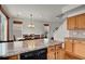 Open-concept kitchen with center island, wood floors, eat in kitchen area, and bright natural lighting at 20826 Robins Dr, Denver, CO 80249