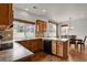 Modern kitchen featuring wood cabinets, a spacious island, and stainless steel appliances with an eat in kitchen at 20826 Robins Dr, Denver, CO 80249