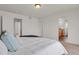 Bright main bedroom features a comfortable bed and ensuite bathroom entrance for added privacy and convenience at 20826 Robins Dr, Denver, CO 80249