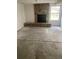 Cozy room featuring a stone fireplace, backyard view, and concrete floors at 482 S Kalispell Way # E, Aurora, CO 80017