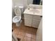Simple bathroom featuring toilet, sink and vanity, with tile flooring at 482 S Kalispell Way # E, Aurora, CO 80017