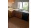 Traditional kitchen with double sink, tile floor, and backyard view at 482 S Kalispell Way # E, Aurora, CO 80017