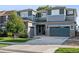 Inviting two-story home with a three-car garage, manicured lawn and a mix of stone and siding exterior at 12740 W 73Rd Pl, Arvada, CO 80005