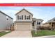 Charming two-story home features a two-car garage and well-maintained front yard at 16175 Peregrine Dr, Parker, CO 80134