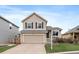 Charming two-story home with a well-maintained lawn and a two-car garage at 16175 Peregrine Dr, Parker, CO 80134