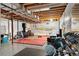 Unfinished basement space with exposed beams and potential for customization; fitness equipment is shown at 3137 E 112Th Pl, Thornton, CO 80233