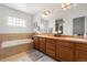 Bright bathroom features a soaking tub and vanity with dual sinks at 3137 E 112Th Pl, Thornton, CO 80233