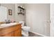 Powder room with a single sink, a dark brown countertop, and a white toilet at 3137 E 112Th Pl, Thornton, CO 80233