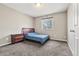 Simple bedroom with natural light and a wooden bed frame with bedside table at 3137 E 112Th Pl, Thornton, CO 80233
