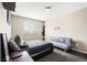 Cozy bedroom with a comfortable bed, futon, and a view from the window at 3137 E 112Th Pl, Thornton, CO 80233