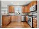 Bright kitchen with stainless steel appliances, wood cabinets, and ample counter space at 3137 E 112Th Pl, Thornton, CO 80233