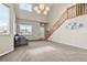 Spacious living room with lots of natural light, staircase, and neutral colors at 3137 E 112Th Pl, Thornton, CO 80233