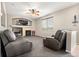 Spacious living room with a fireplace, built-in shelving, and two leather chairs at 3137 E 112Th Pl, Thornton, CO 80233