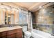 Bathroom with shower/tub combo, slate tile, and wood vanity at 12555 Critchell Ln, Littleton, CO 80127