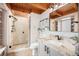 Bright bathroom featuring a glass shower, granite vanity, and neutral tile at 12555 Critchell Ln, Littleton, CO 80127